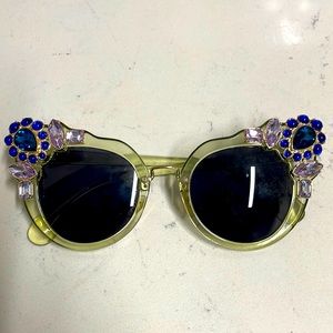 Venetian sunglasses that are very jewel adorned and fashionable.